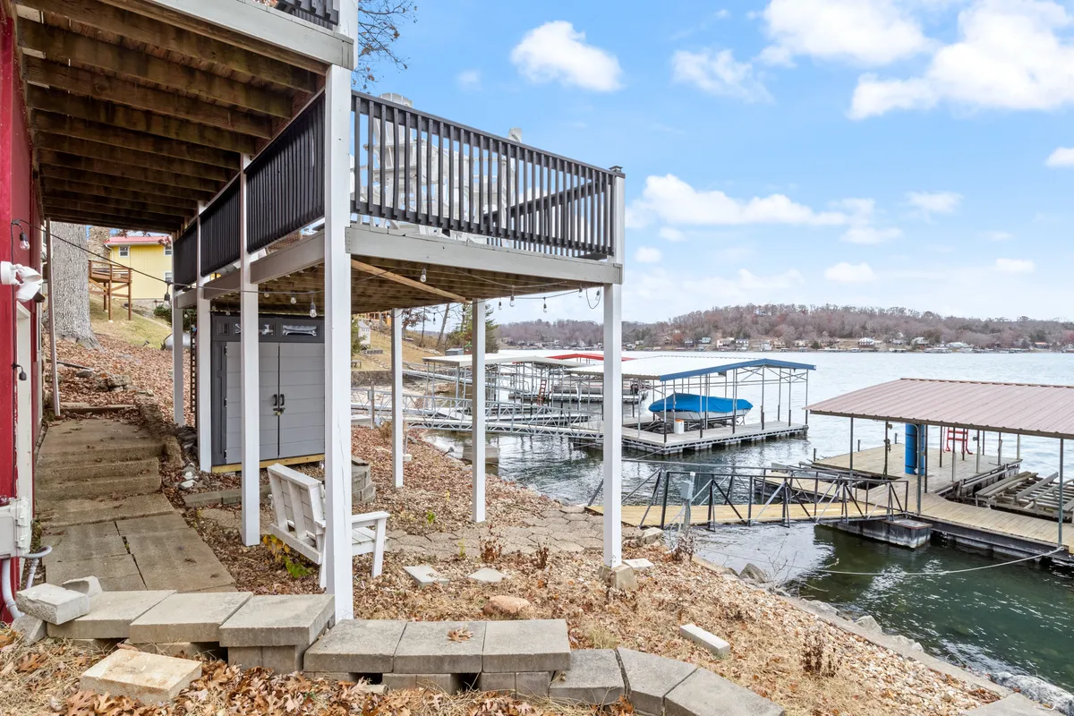 A welcoming dock area with waterfront views, deck space, and stairs leading down to the lake. The setting is perfect for boating, fishing, relaxing on the deck, or hosting summer barbecues by the water.